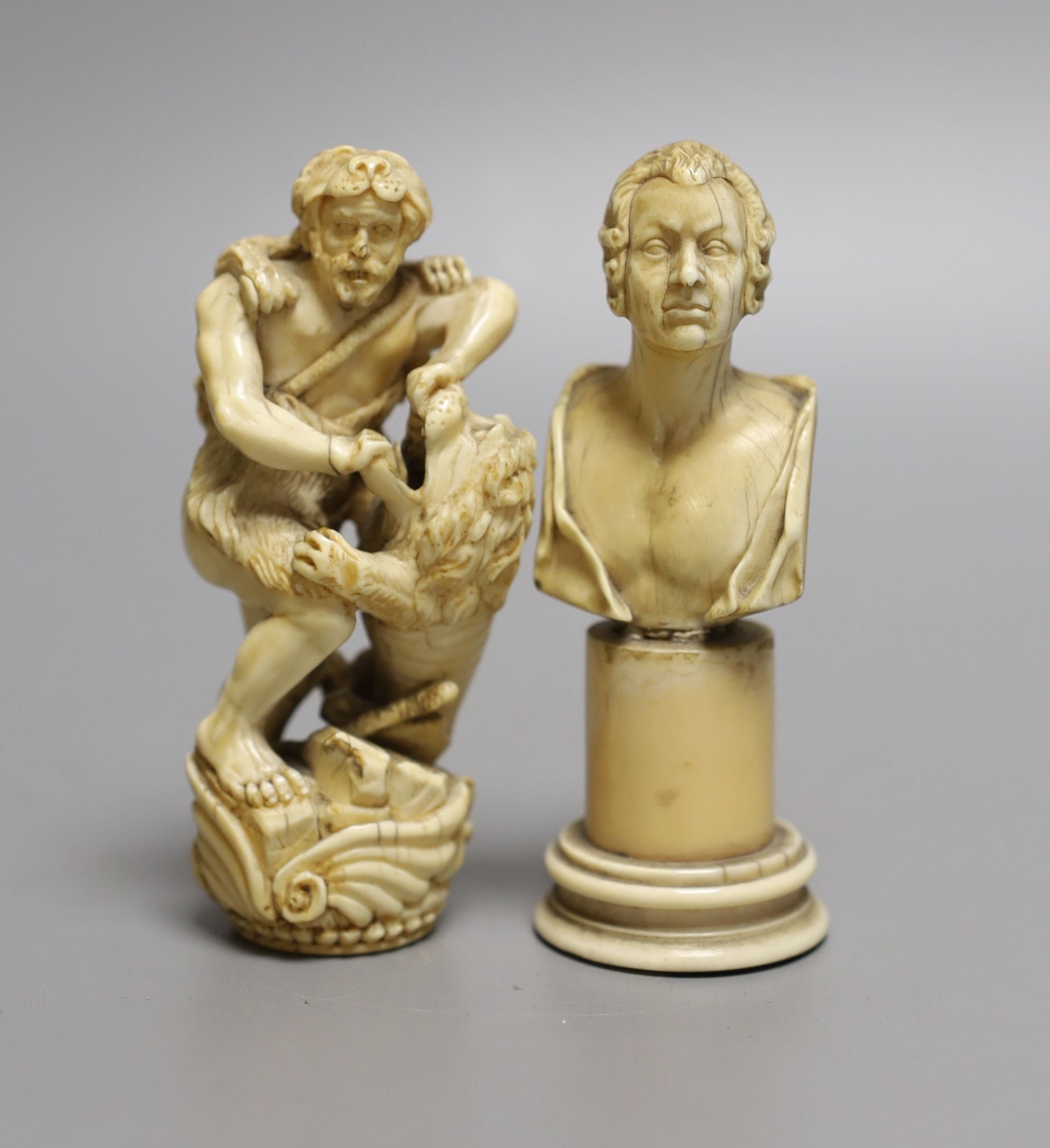 An ivory finial or cane handle in the form of Hercules fighting a lion and an ivory bust of a gentleman on a pedestal, both 18th/19th century, finial 9.5 cms high.